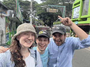 Daniela Woldenberg and others in India, with a sign that says "Jew Town" behind them.