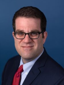Picture of David Adesnik, in a suit and glasses.