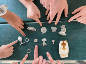 Fellows pointing to artistic creations they made.